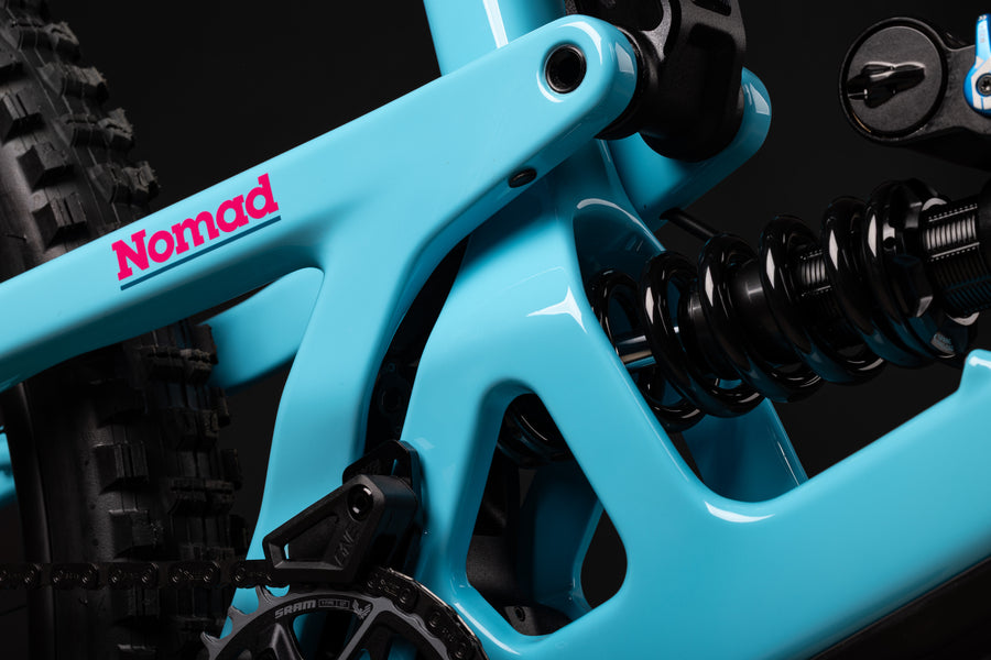 Close-up of a teal mountain bike with 'Norton' branding on a black background