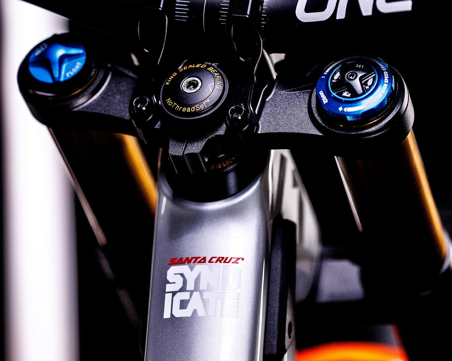 Close-up of a Santa Cruz bicycle suspension fork with blue accents.