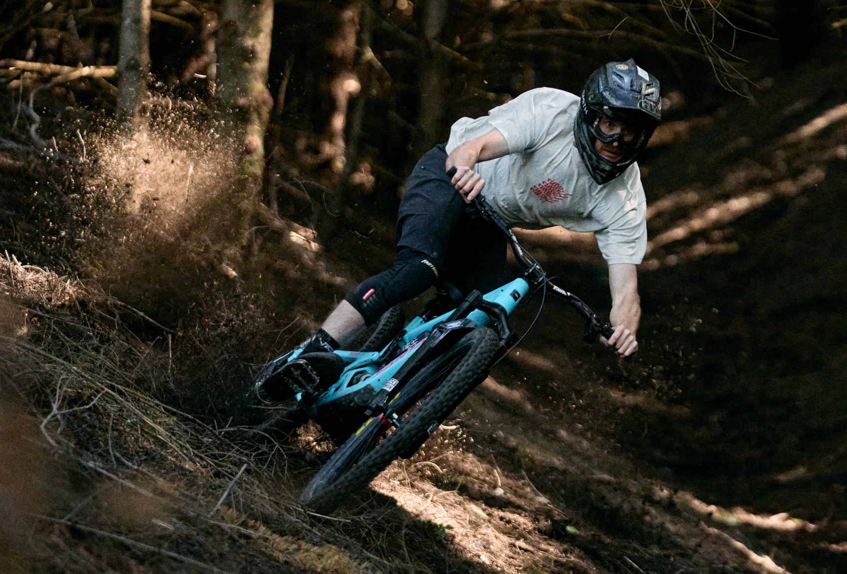 Person riding a mountain bike through a forest trail