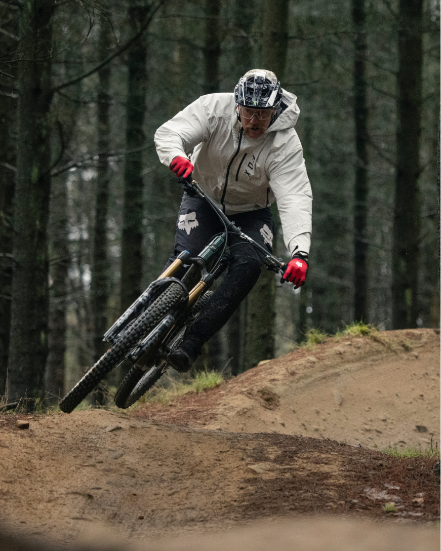Person riding a mountain bike on a trail in a forest